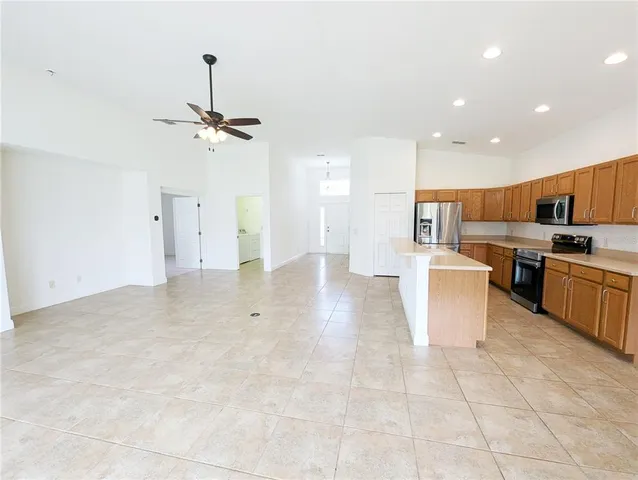 a view of a kitchen with a sink and a refrigerator
