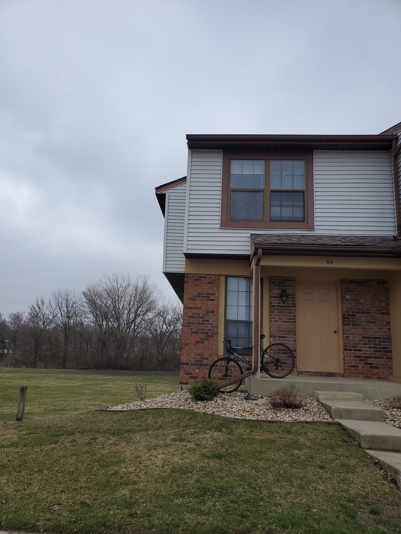 700 North Adelaide Street, Unit 49 Normal, IL 61761 - Photo 15 of 15 a front view of a house with garden