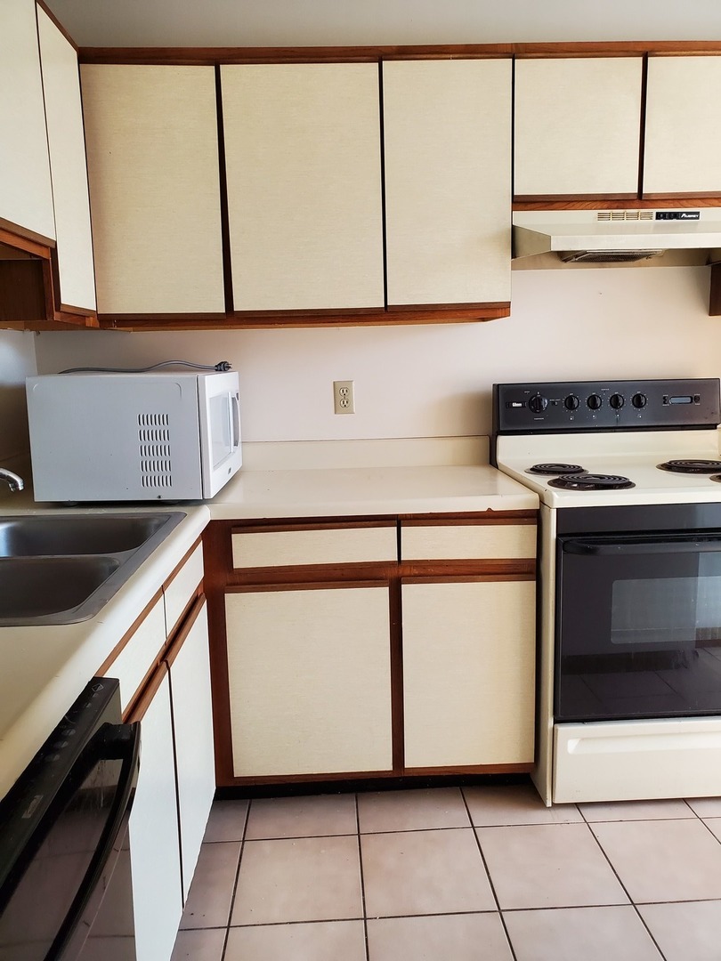 700 North Adelaide Street, Unit 49 Normal, IL 61761 - Photo 7 of 15 a kitchen with a stove and a microwave