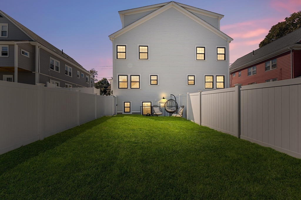 11 Lowell Street, Unit B Arlington, MA 02476 - Photo 25 of 31 a backyard of a house with table and chairs