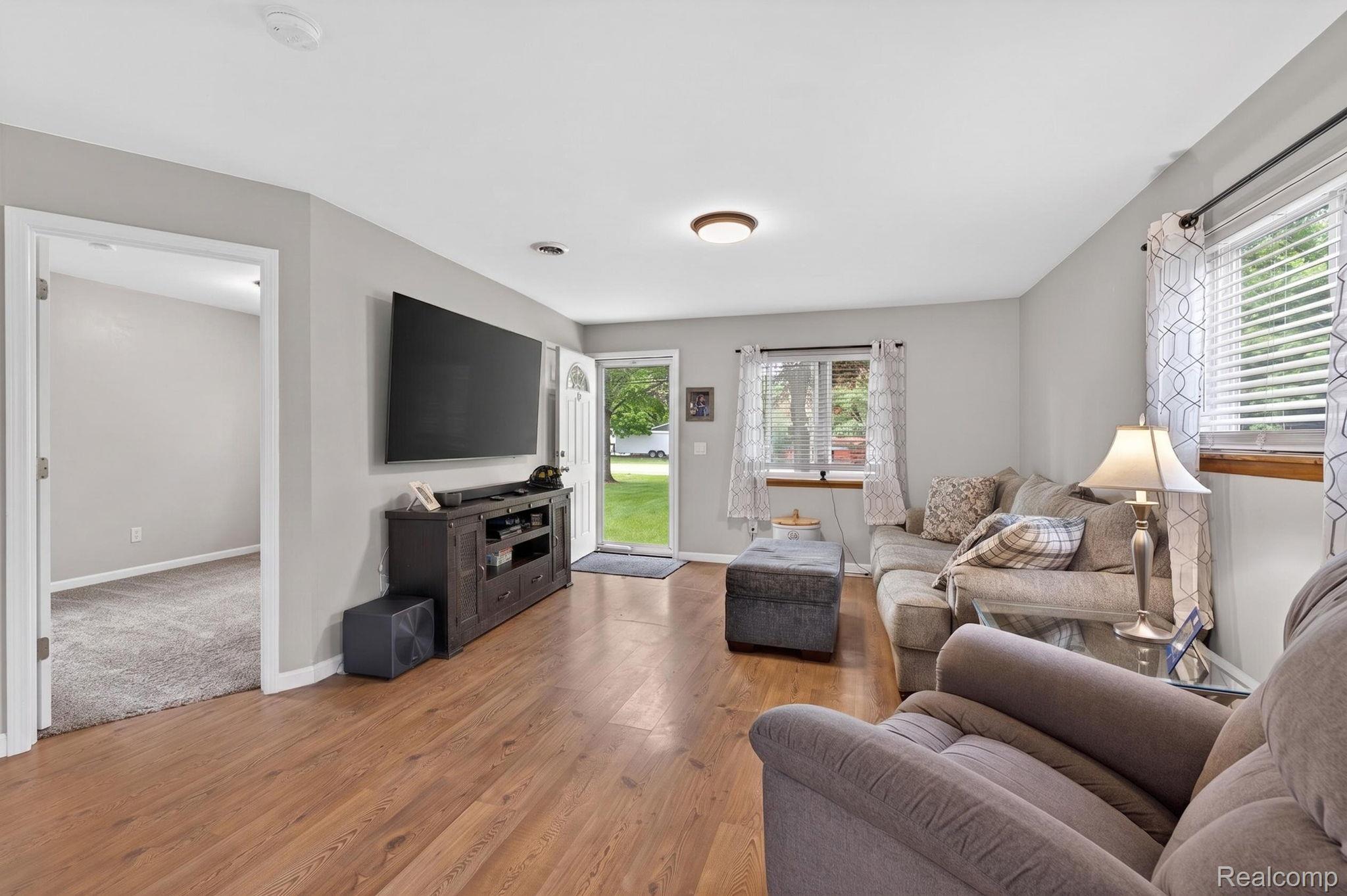 6354 Lapeer Road Burton, MI 48509 - Photo 14 of 44 Living area with light wood finished floors and baseboards