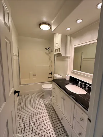 a bathroom with a double vanity sink toilet mirror and shower