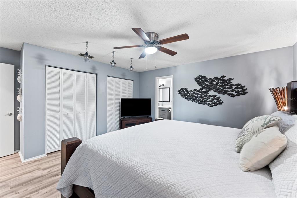 29 Pelican Lane Edgewater, FL 32141 - Photo 18 of 39 a bedroom with a large bed and a chandelier