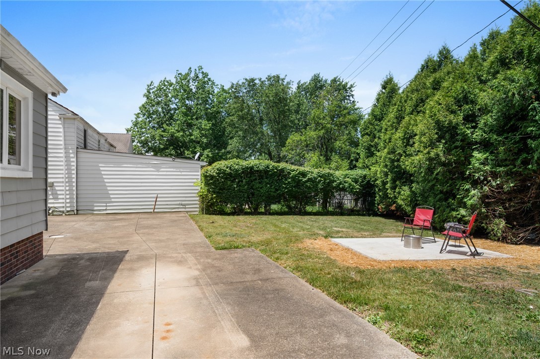 22625 Rye Road Shaker Heights, OH 44122 - Photo 38 of 38 Expansive backyard featuring a concrete patio, mature perimeter trees, and a manicured lawn
