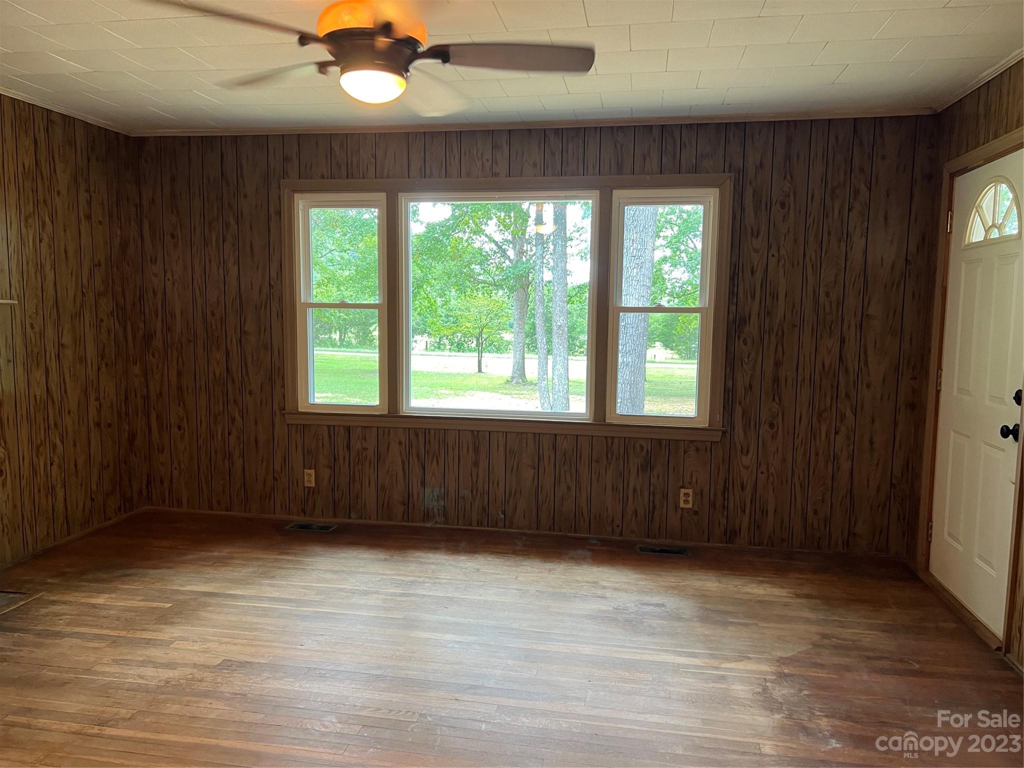 4982 Tabernacle Road Lancaster, SC 29720 - Photo 12 of 22 an empty room with wooden floor and windows