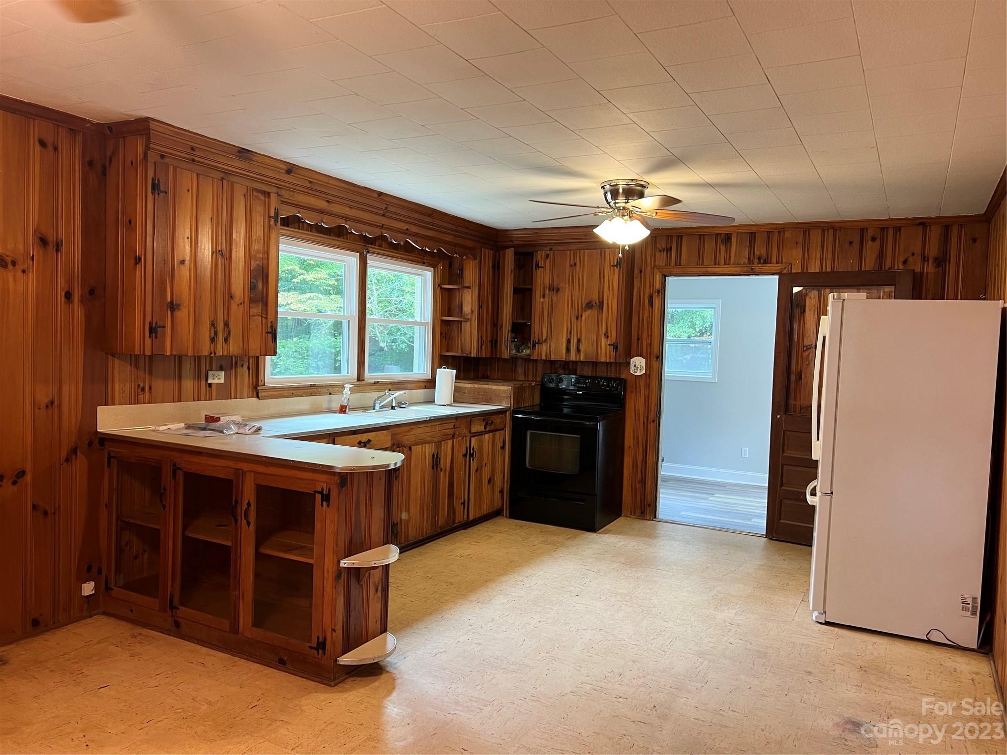 4982 Tabernacle Road Lancaster, SC 29720 - Photo 6 of 22 a kitchen with a stove a refrigerator and a fireplace