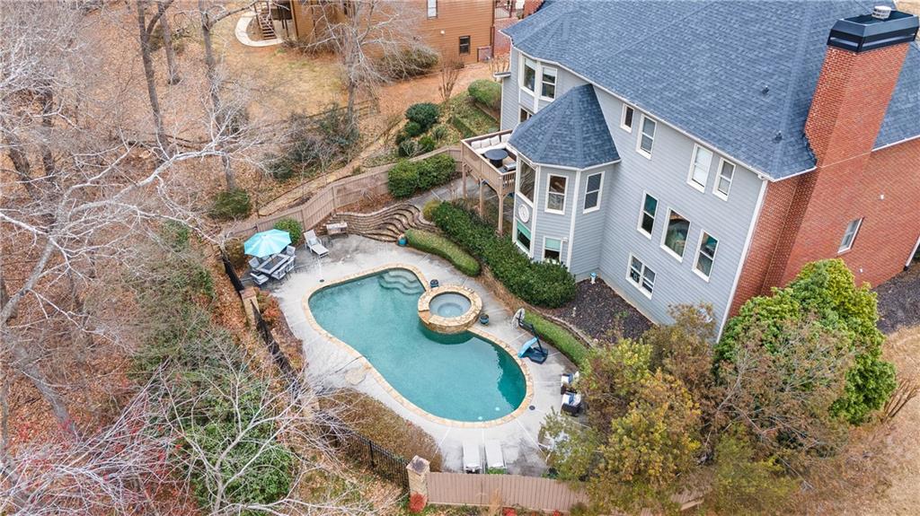 an aerial view of a house with garden space and sitting area