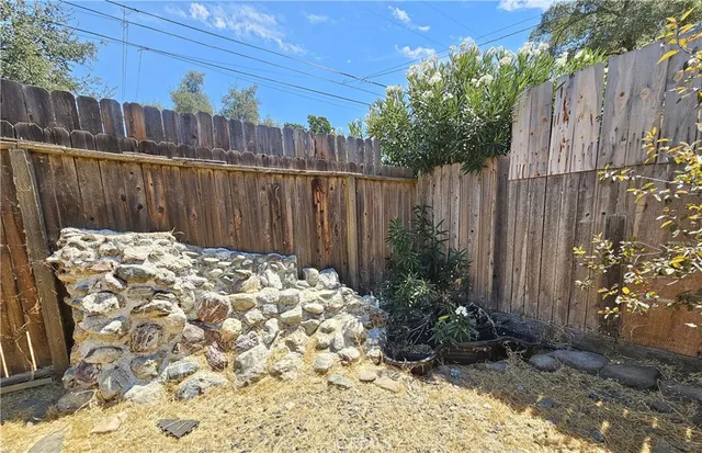 a view of a backyard with wooden fence