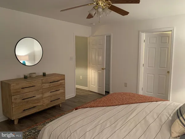 a bedroom with a bed and a mirror