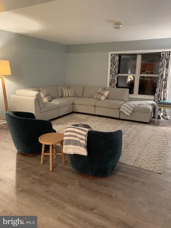 a view of a livingroom with furniture and wooden floor