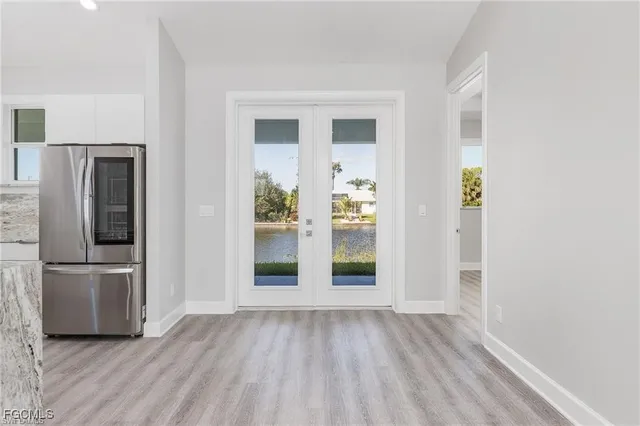 a view of kitchen with furniture and refrigerator