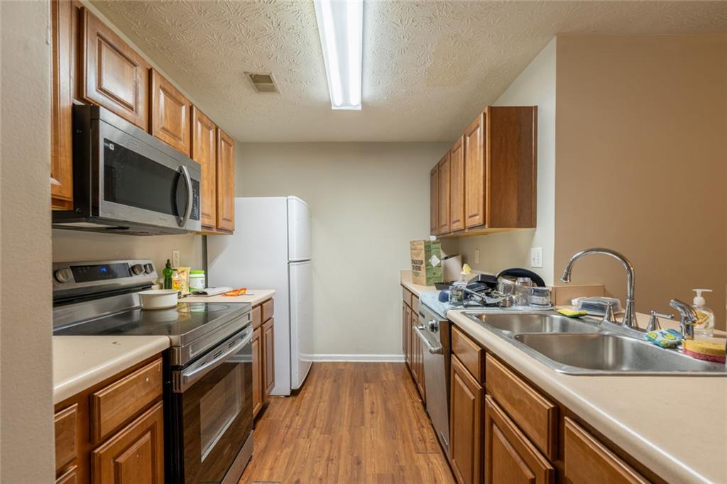 3474 Waldrop Trail Decatur, GA 30034 - Photo 4 of 17 a kitchen with stainless steel appliances granite countertop a sink stove microwave refrigerator and cabinets