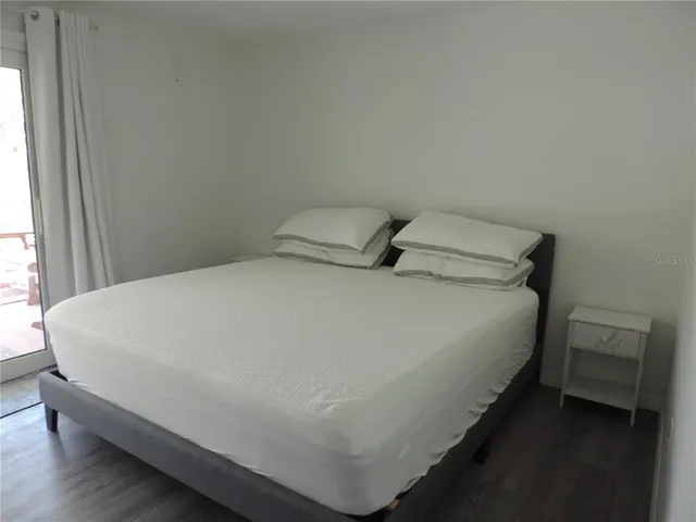 a bed sitting in a bedroom next to a window