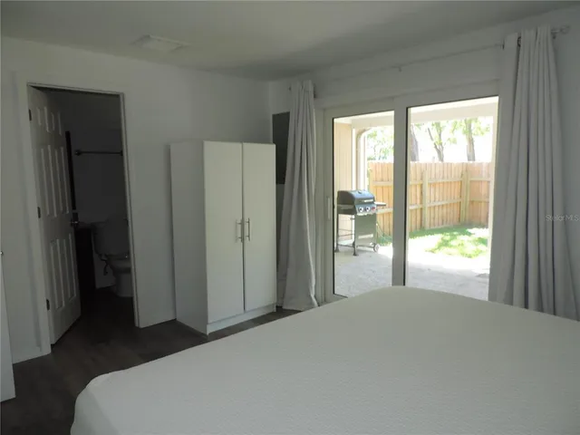 a bedroom with a bed and a large window