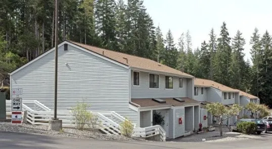 a front view of a house with trees