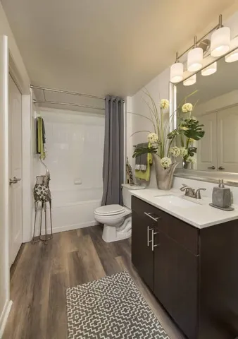 a bathroom with a sink a toilet and a mirror