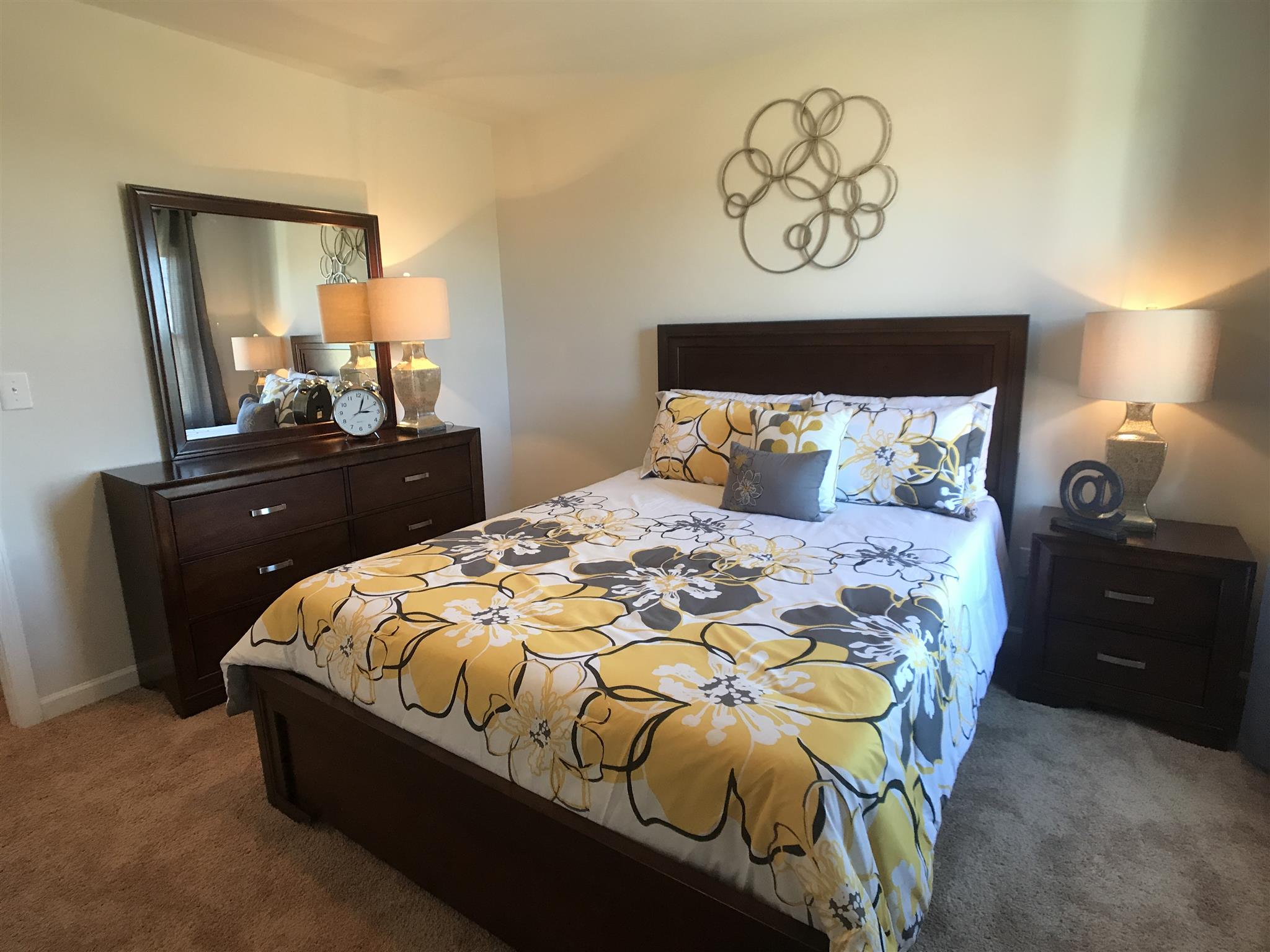 765 Prominence Road, Unit 109 Columbia, TN 38401 - Photo 16 of 30 a bedroom with a bed and a mirror on dresser