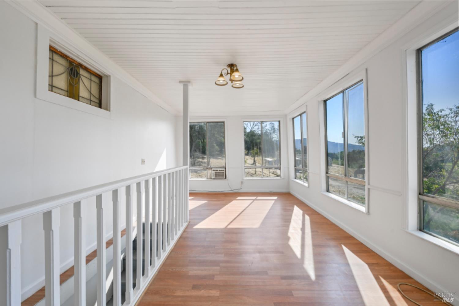 31258 Highway 128 Cloverdale, CA 95425 - Photo 31 of 88 a view of a hallway with wooden floor and windows