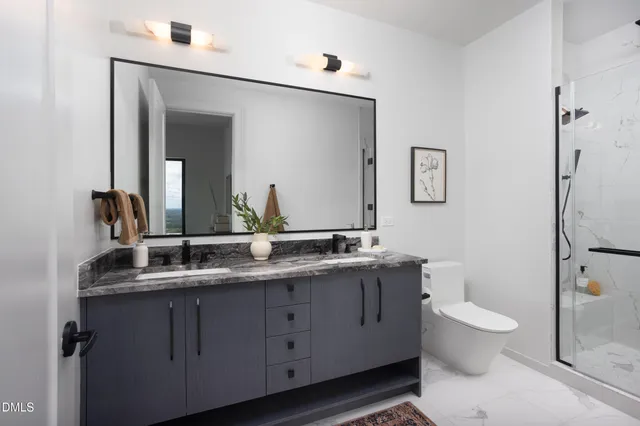 a bathroom with a toilet sink and mirror