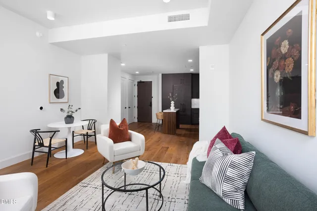 a living room with furniture and a wooden floor