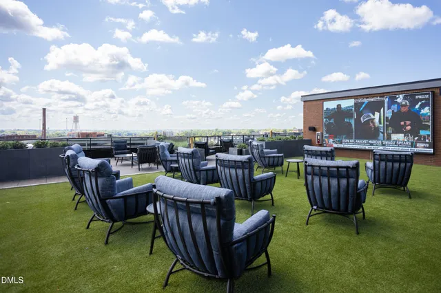 a view of a swimming pool with outdoor seating