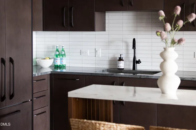 a kitchen with a sink a counter top space and cabinets