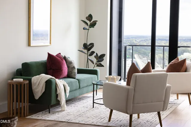 a living room with furniture and a floor to ceiling window