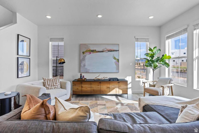 488 West Greenstone Pl Street, Unit 1010 St. George, UT 84790 - Photo 8 of 34 Open-concept living space featuring high ceilings, recessed lighting, wood-finish flooring, and multiple large windows with blinds