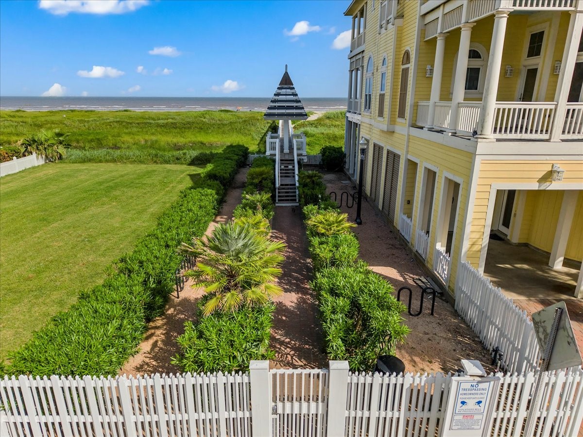 726 Positano Road Galveston, TX 77550 - Photo 16 of 20 a view of a pathway of a patio with wooden fence