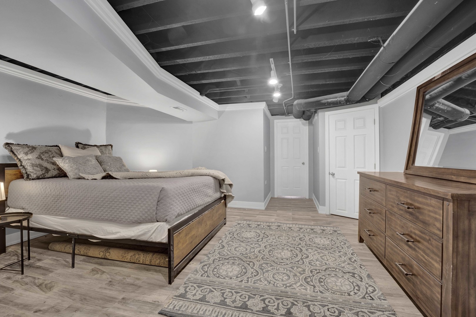 3806 South Indiana Avenue Chicago, IL 60653 - Photo 27 of 35 a spacious bedroom with a bed and a dresser