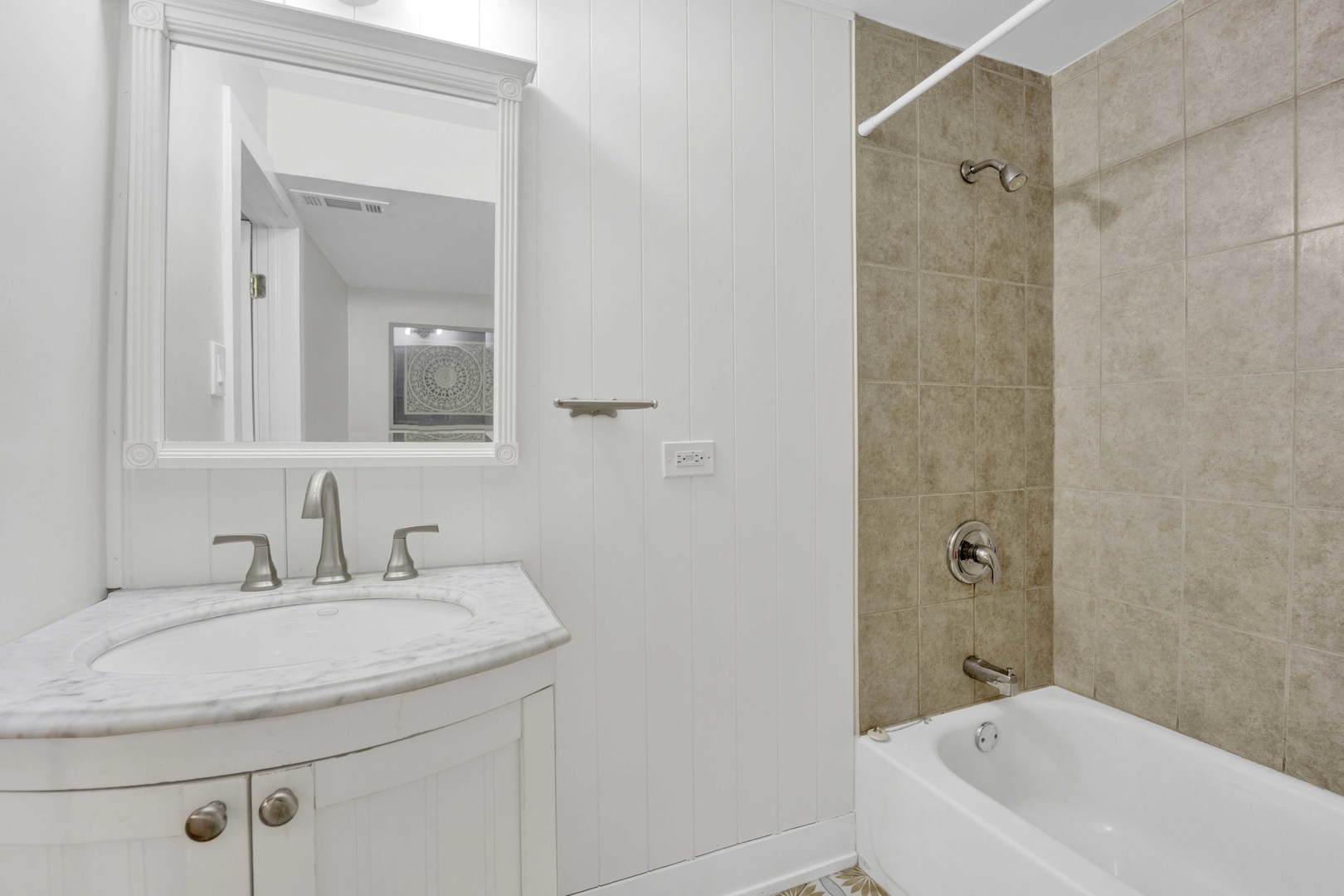 3806 South Indiana Avenue Chicago, IL 60653 - Photo 29 of 35 a bathroom with a granite countertop sink a mirror and a bathtub