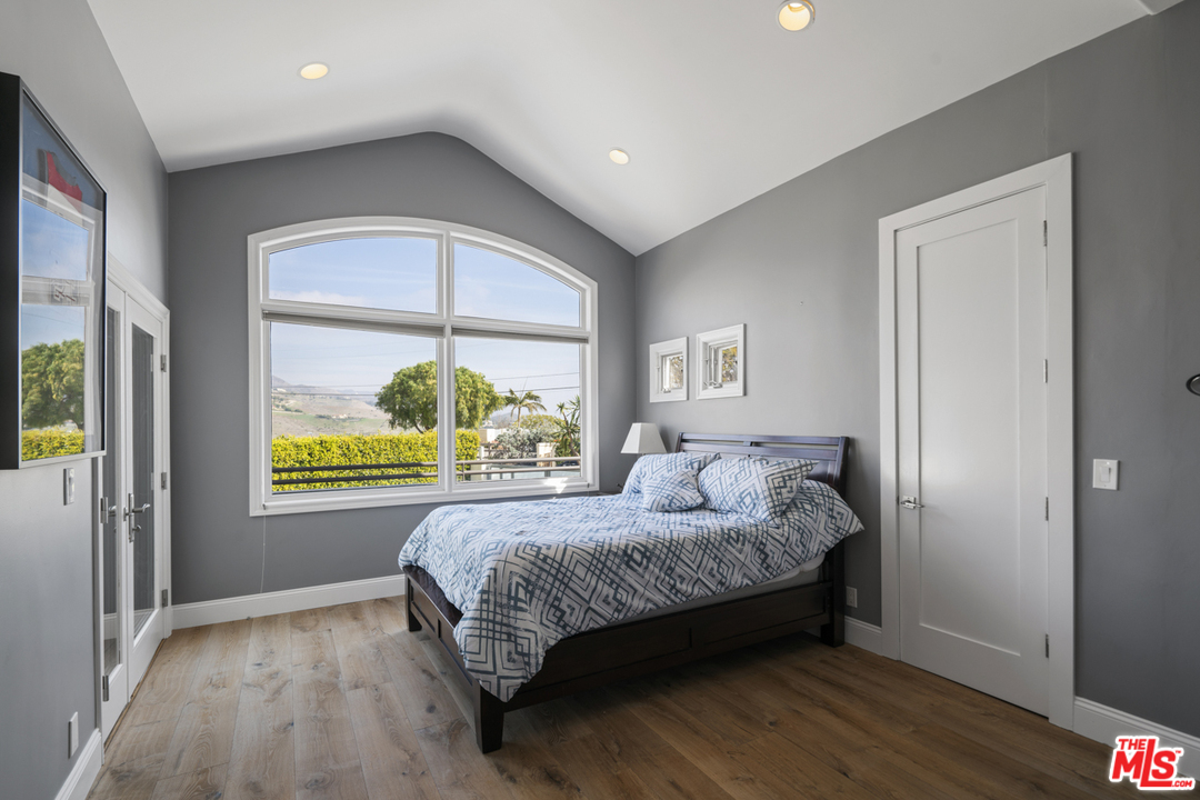 6165 Zumirez Drive Malibu, CA 90265 - Photo 21 of 33 a bedroom with a bed and a window
