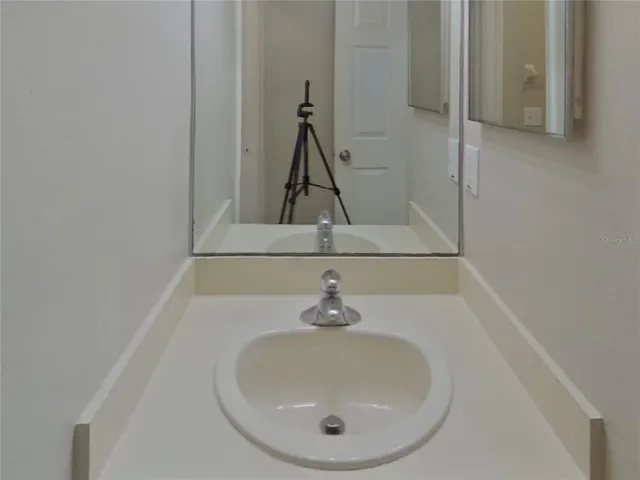 a bathroom with a sink and mirror