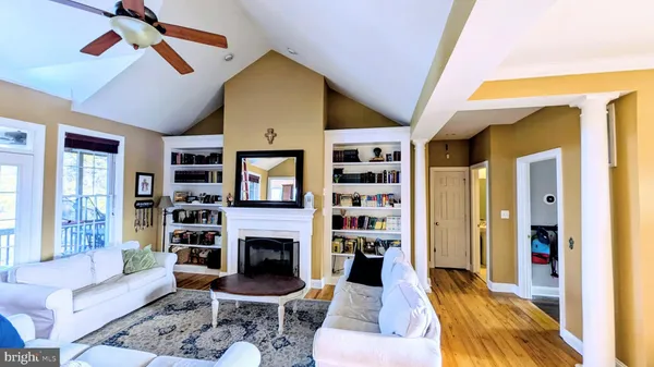 a hallway with wooden floor table and chairs