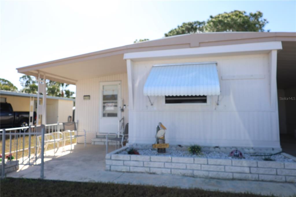 a view of a house with backyard porch and sitting area