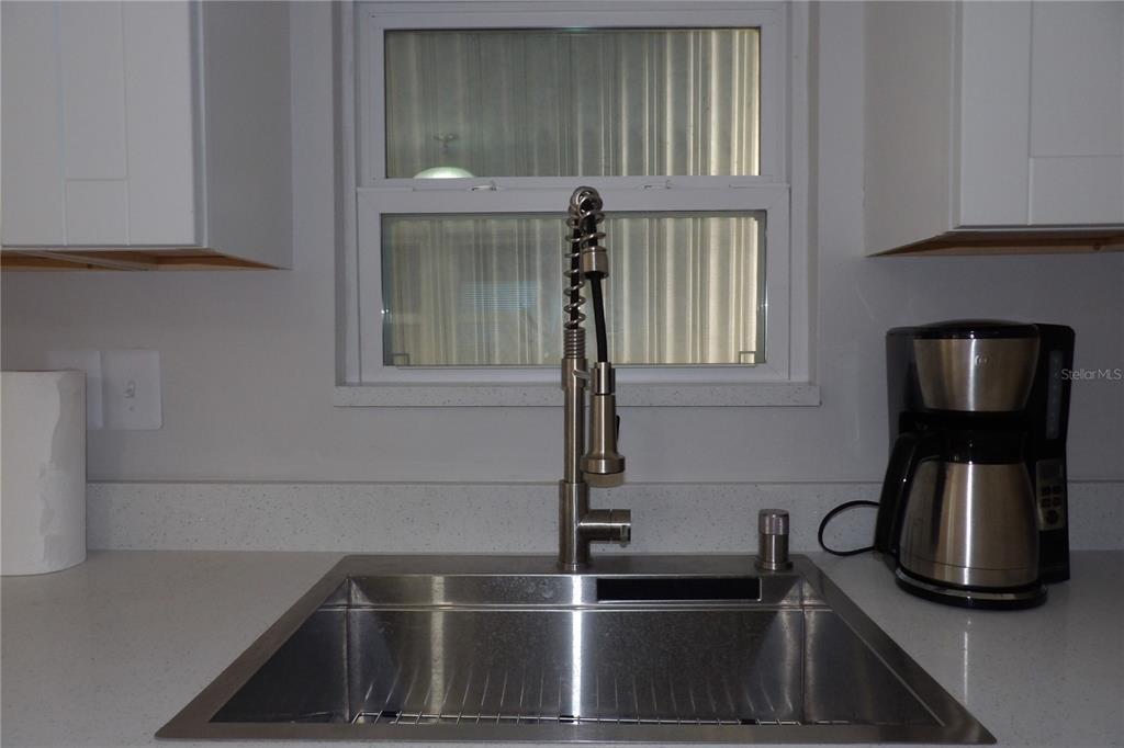 6608 Roosevelt Drive Port Richey, FL 34668 - Photo 19 of 39 a kitchen with a sink and a window