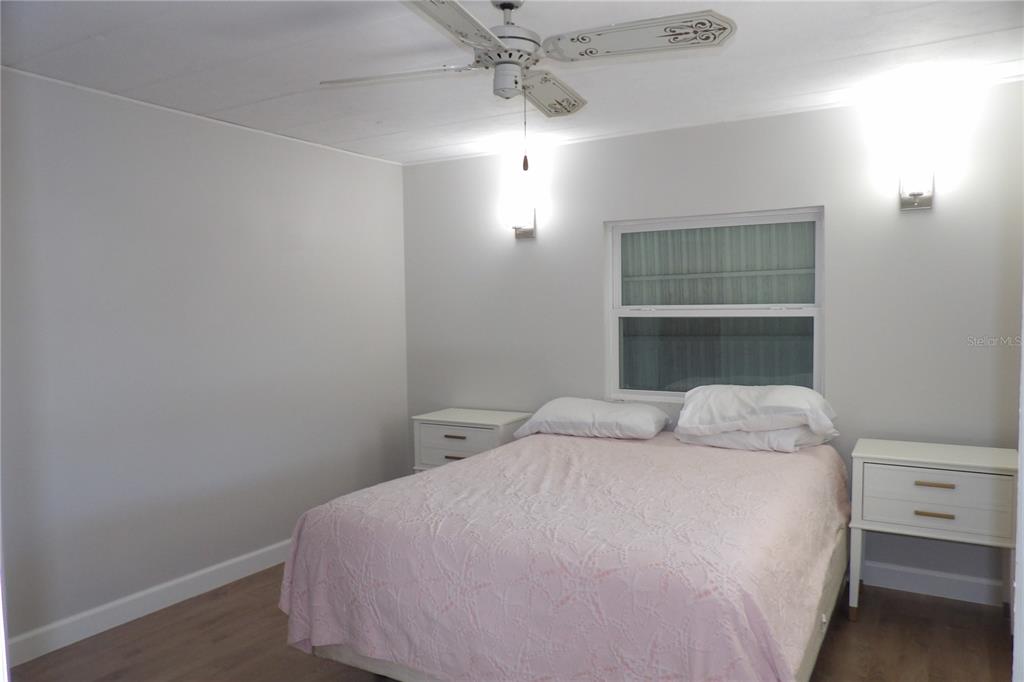 6608 Roosevelt Drive Port Richey, FL 34668 - Photo 22 of 39 a bedroom with a bed and a ceiling fan