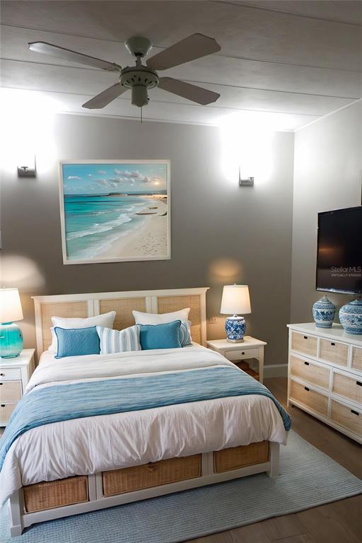 6608 Roosevelt Drive Port Richey, FL 34668 - Photo 28 of 39 a bedroom with a bed and a flat screen tv