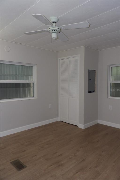 6608 Roosevelt Drive Port Richey, FL 34668 - Photo 29 of 39 a view of an empty room with wooden floor and a window