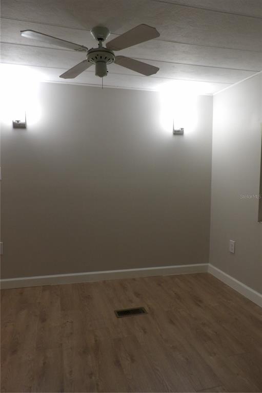 6608 Roosevelt Drive Port Richey, FL 34668 - Photo 30 of 39 an empty room with a window and a fan