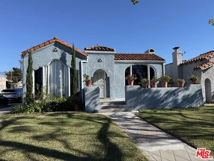 a front view of a house with a garden