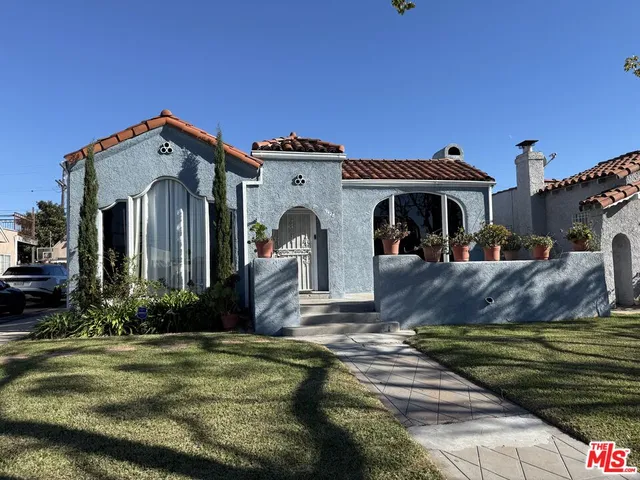 a front view of a house with a garden