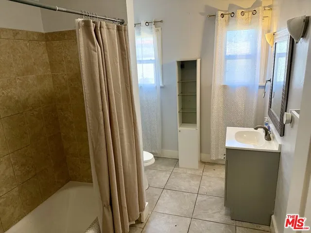 a bathroom with a shower and a sink