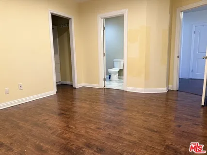 a view of wooden floor and brick walls