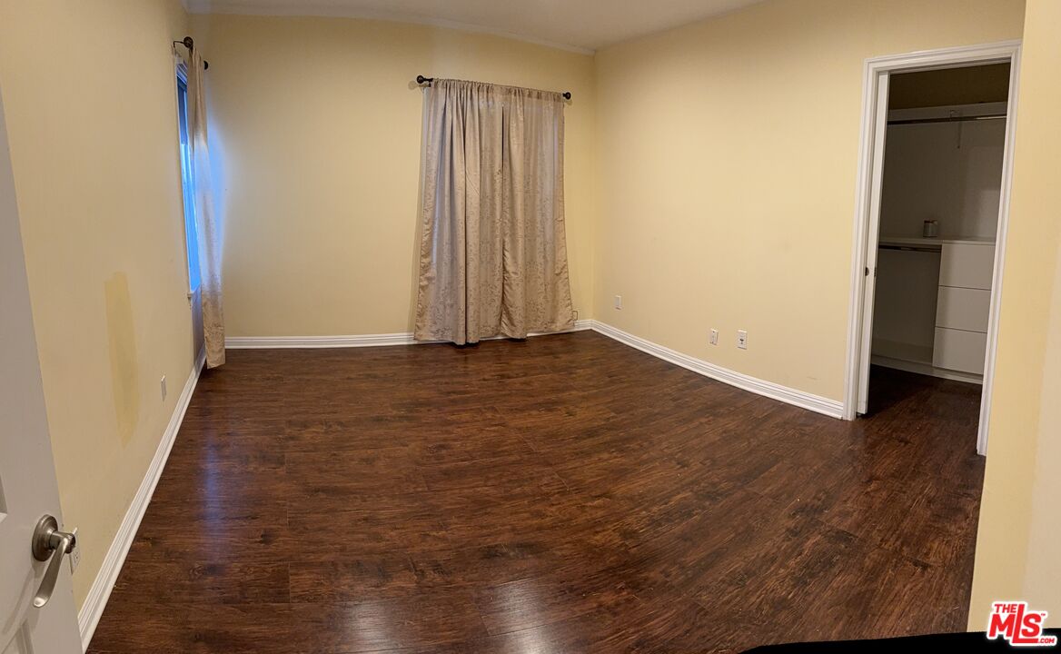9428 Harvard Boulevard Los Angeles, CA 90047 - Photo 14 of 18 a view of a room with wooden floor and a window