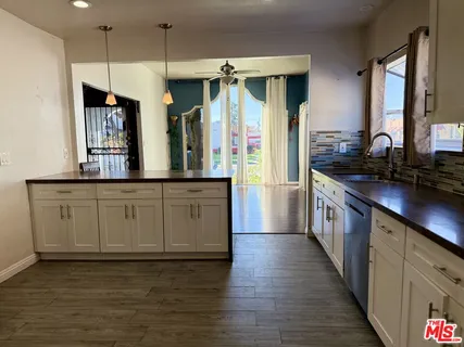 a kitchen with stainless steel appliances granite countertop a sink and cabinets