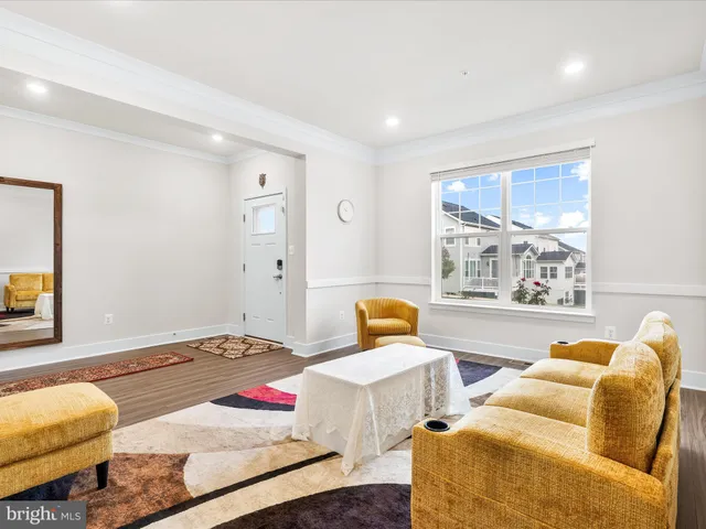 a view of a hallway with a livingroom and entryway
