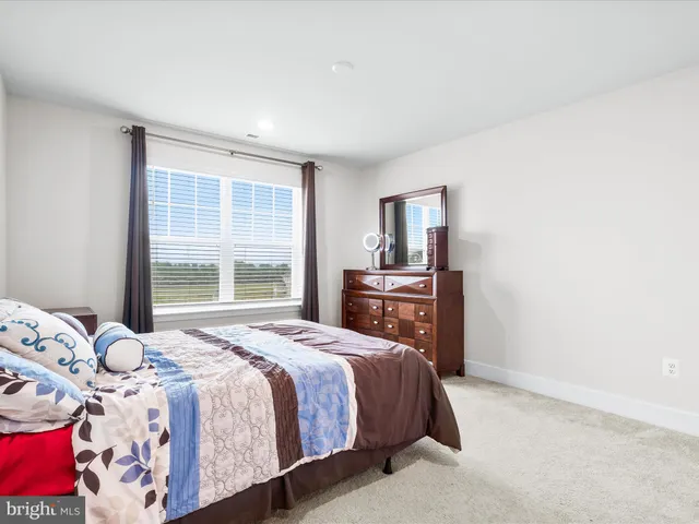 a living room with furniture a rug and kitchen view