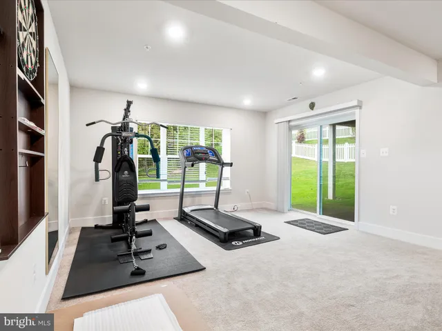 a view of a house with a big yard and large trees