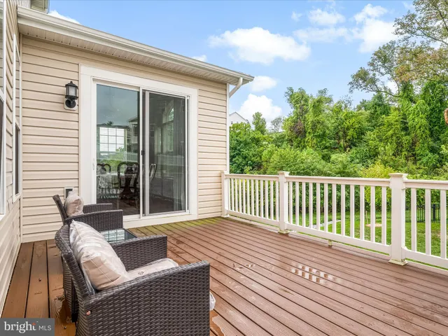 a front view of a house with a garden and trees